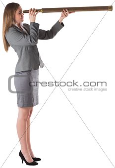 Businesswoman looking through a telescope
