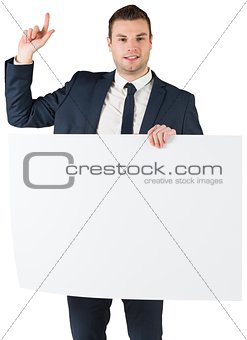Businessman holding card and pointing