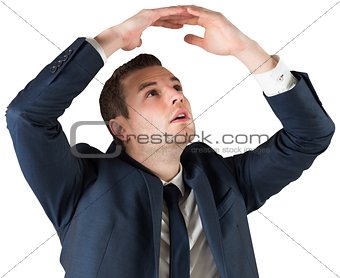 Businessman standing with hands over head