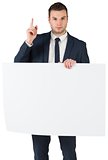 Businessman holding card and pointing up