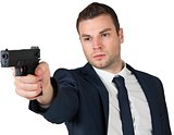 Serious businessman pointing a gun