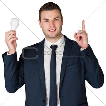 Businessman holding light bulb and pointing