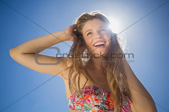 Beautiful smiling blonde in floral bikini on the beach