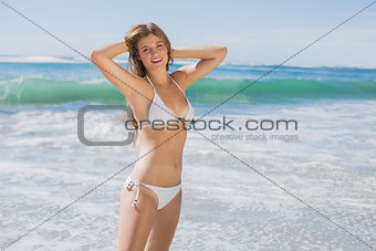 Beautiful fit woman in white bikini on the beach