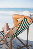 Slim woman relaxing in deck chair on the beach