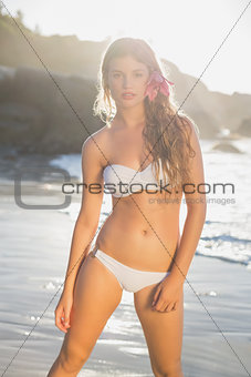 Beautiful blonde in white bikini on the beach