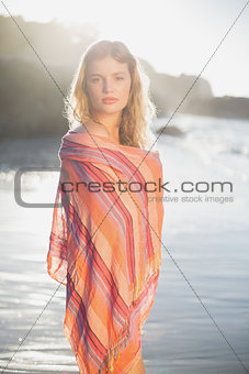 Beautiful blonde wrapped in scarf at the beach