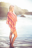 Beautiful blonde wrapped in scarf at the beach
