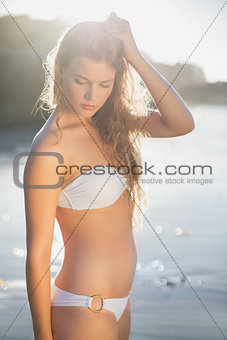 Beautiful blonde in white bikini at the beach