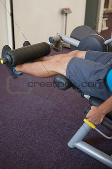 Man using weights machine for legs