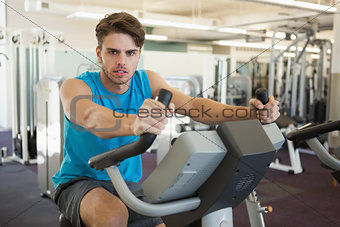 Focused man on the exercise bike