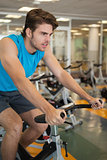 Focused fit man on the spin bike