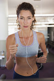 Fit focused woman running on the treadmill