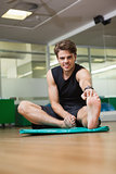 Fit man warming up in fitness studio