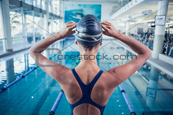 Pretty swimmer standing by the pool