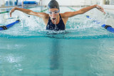 Fit swimmer doing the butterfly stroke in the swimming pool