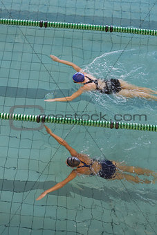 Female swimmers racing in the swimming pool