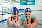 Female swimmers smiling at camera in the swimming pool