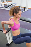 Fit woman exercising using the bench