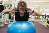 Fit man balancing on exercise ball