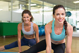 Fit women stretching on exercise mats