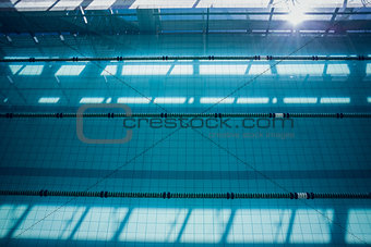Large swimming pool with sunlight streaming in