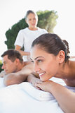 Attractive couple enjoying couples massage poolside