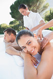 Attractive couple enjoying couples massage poolside