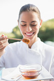 Smiling beauty therapist holding plate with honey