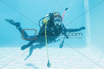 Woman on scuba training submerged in swimming pool