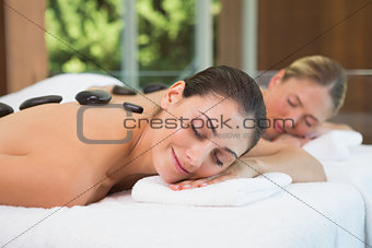 Pretty friends getting hot stone massages together