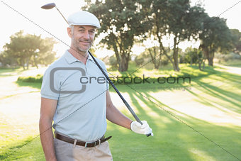 Smiling handsome golfer looking at camera