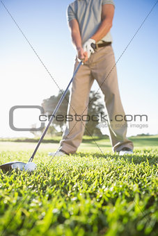 Golfer about to hit golf ball