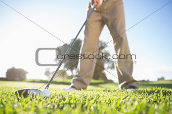 Golfer about to hit golf ball