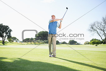 Concentrating golfer taking a shot