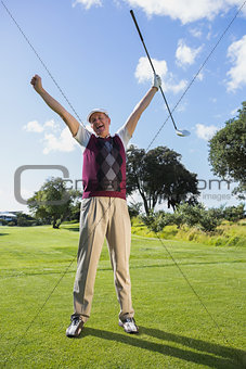 Excited golfer cheering and looking at camera