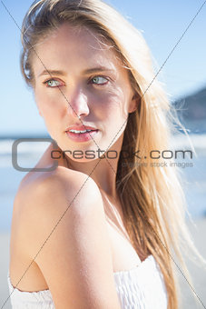Woman in white dress posing on the beach