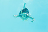 Brunette swimming underwater wearing snorkel
