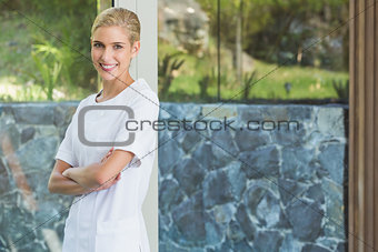 Blonde beauty therapist smiling at camera