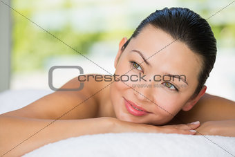 Smiling brunette lying on massage table