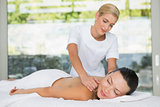 Content brunette getting a back massage