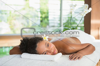 Gorgeous woman lying on massage table with salt treatment on back