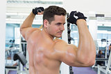 Shirtless bodybuilder flexing his biceps