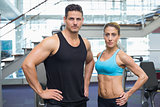 Bodybuilding man and woman frowning at camera
