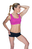 Female bodybuilder posing in pink sports bra