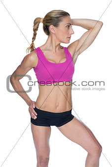Female bodybuilder posing in pink sports bra