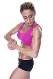 Female bodybuilder flexing in pink sports bra