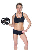 Female bodybuilder holding large black dumbbell with arm up looking at camera