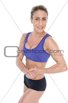 Strong blonde posing with hands together