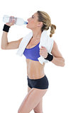 Strong blonde drinking from water bottle